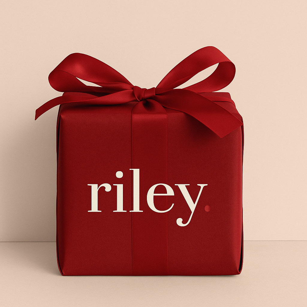 Red gift box with a bow and 'riley' text on a beige background